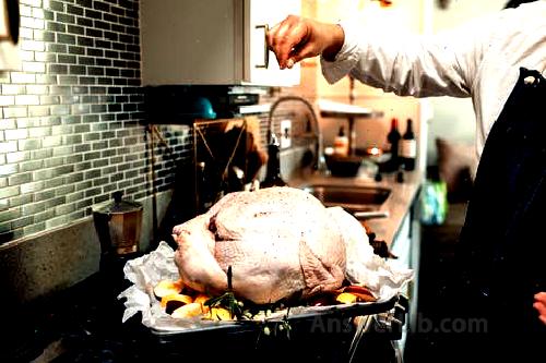 People holding raw chicken