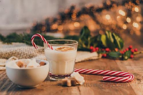 Milk transparent water cup near candy cane